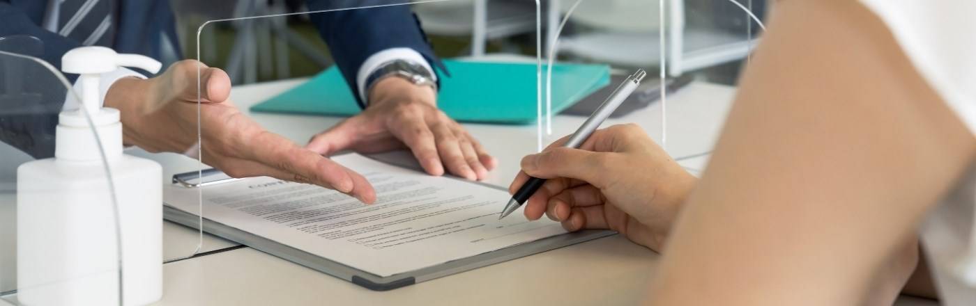 woman signing a contract