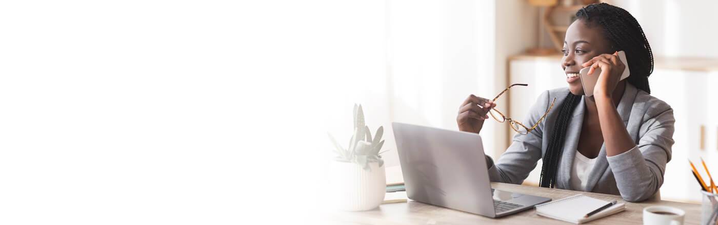 Businesswoman on laptop and smartphone