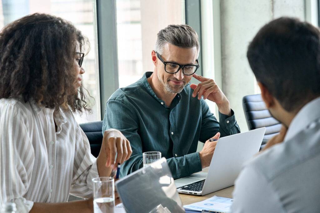 coworkers around a table chatting together