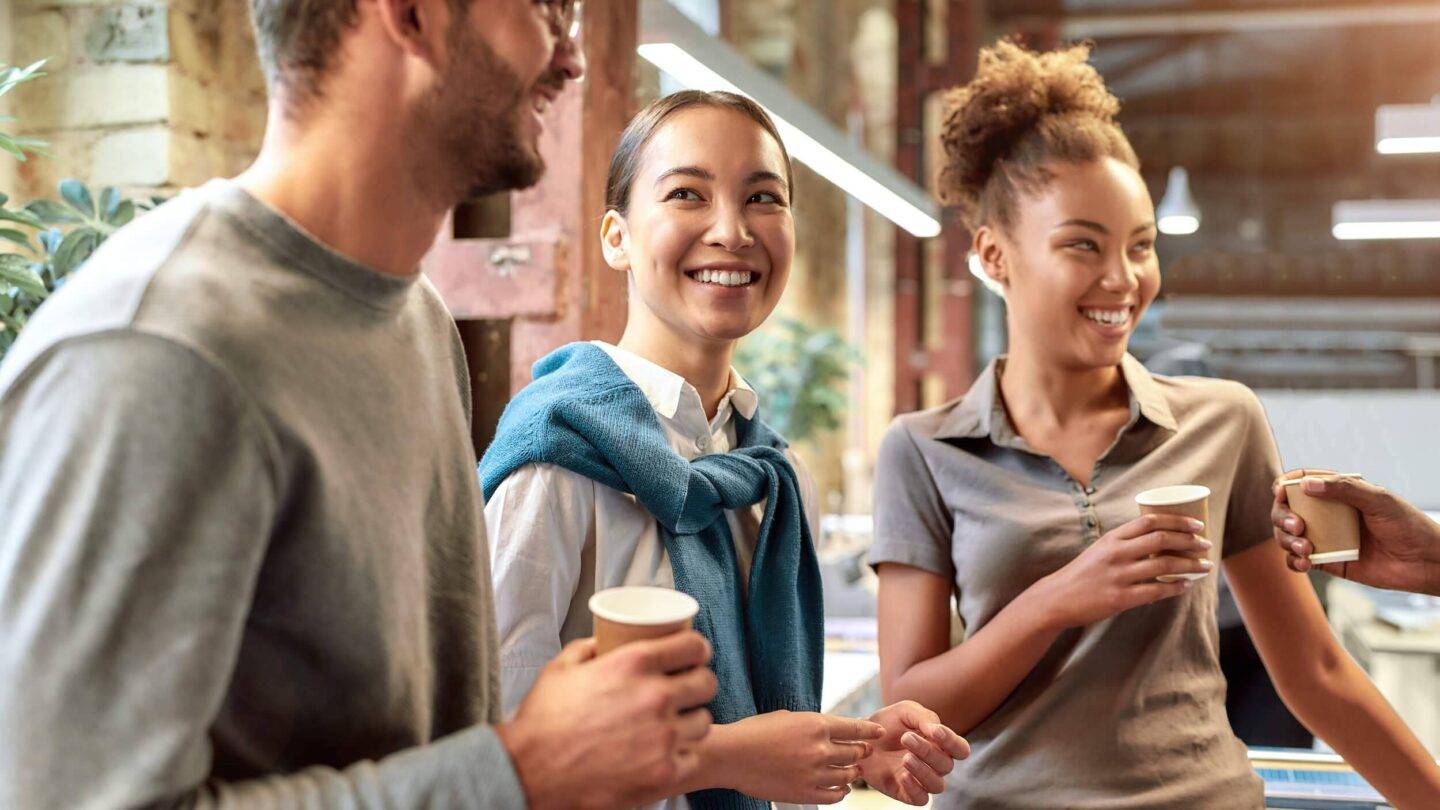 people talking and smiling over coffee