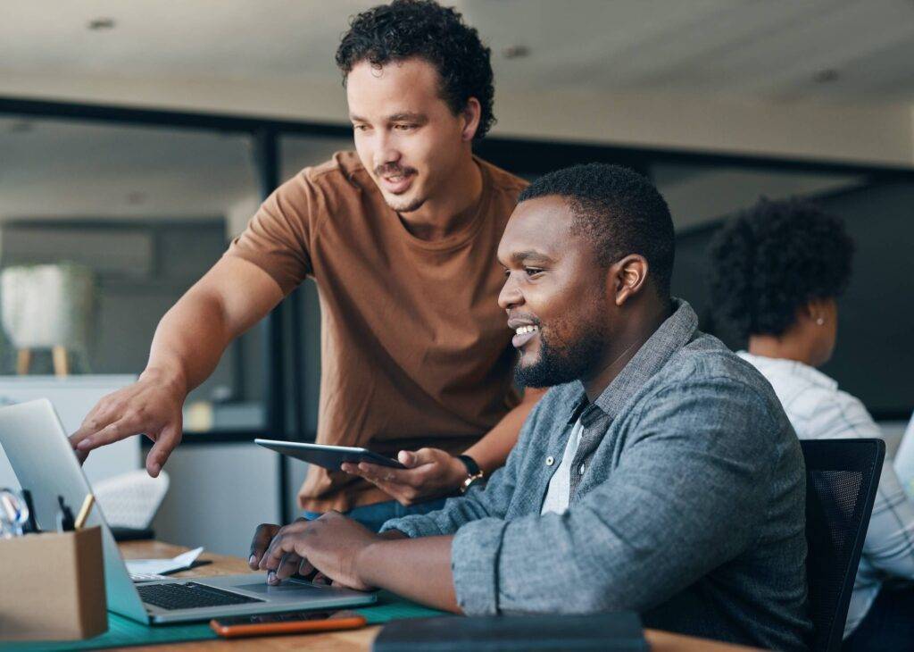 Shot of two young businessmen working together in an office.