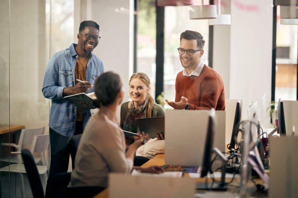 People in an office talking around a desk