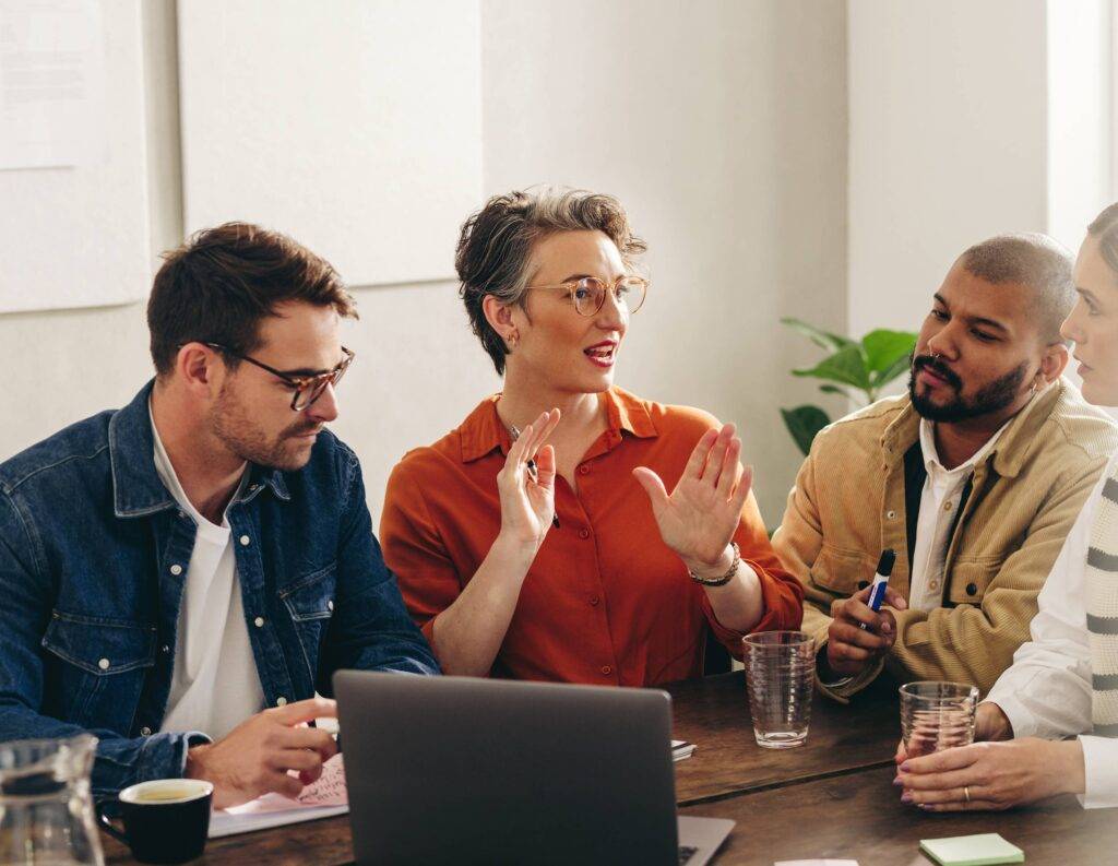 people talking over a laptop