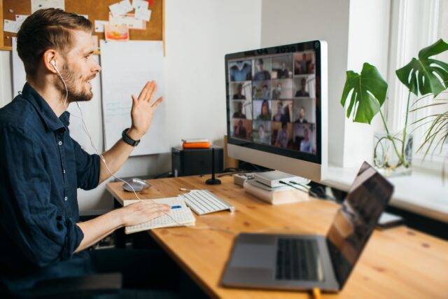 Man sitting at desk having an online meeting