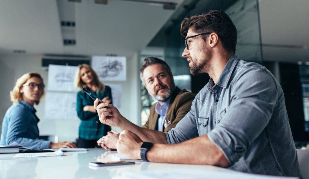 A group of colleagues in a meeting in an office setting