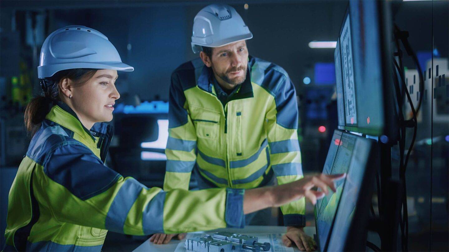 workers in high vis and helmets