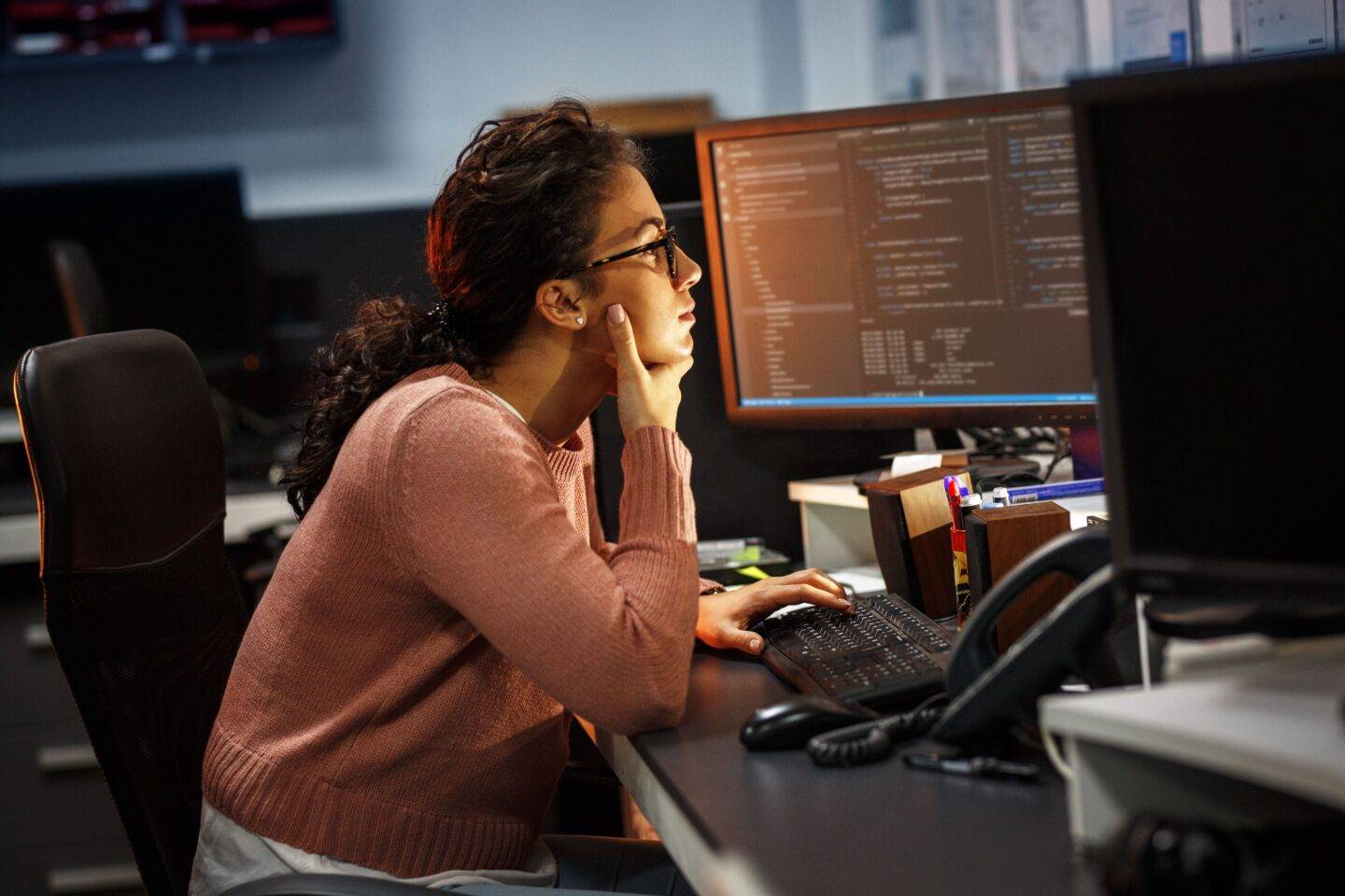 Woman working at night at the office on computer