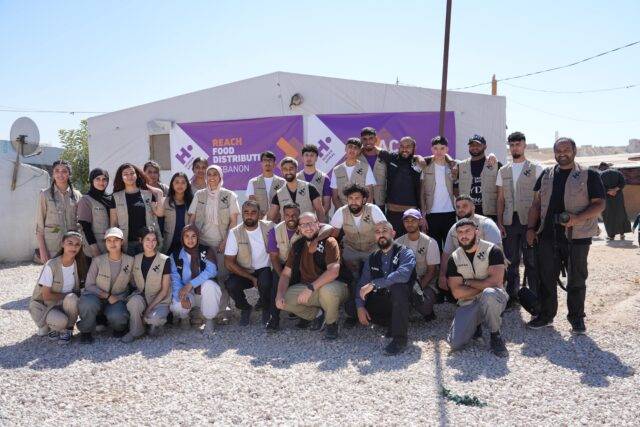 group of people stood in front of charity sign